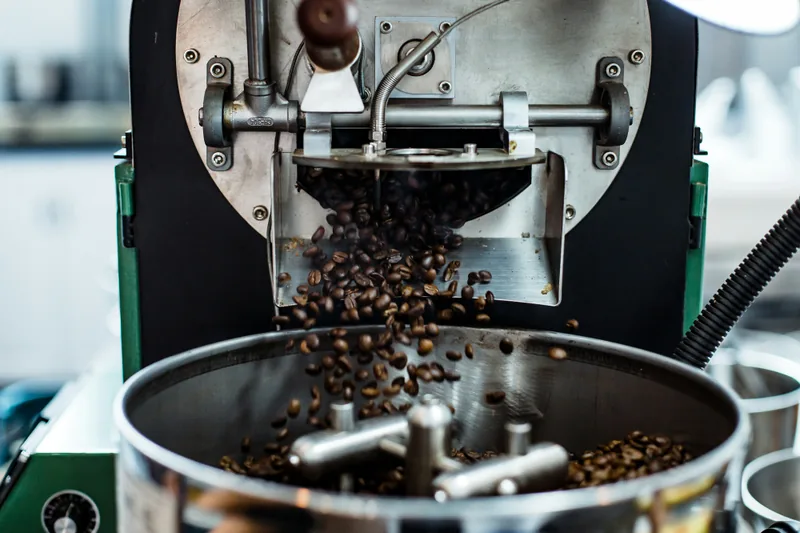 Roasted beans falling from the roaster into the cooling tray