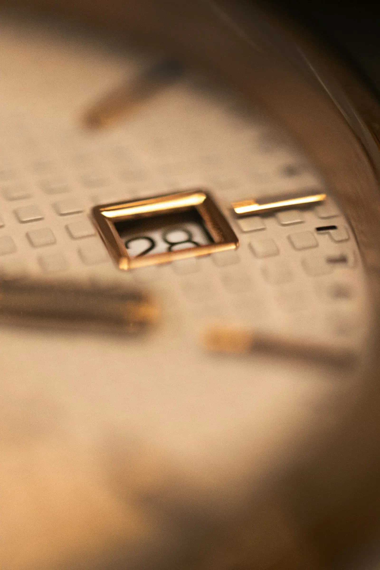 M-01 Champagne — Champagne guilloché under a gold-framed date.