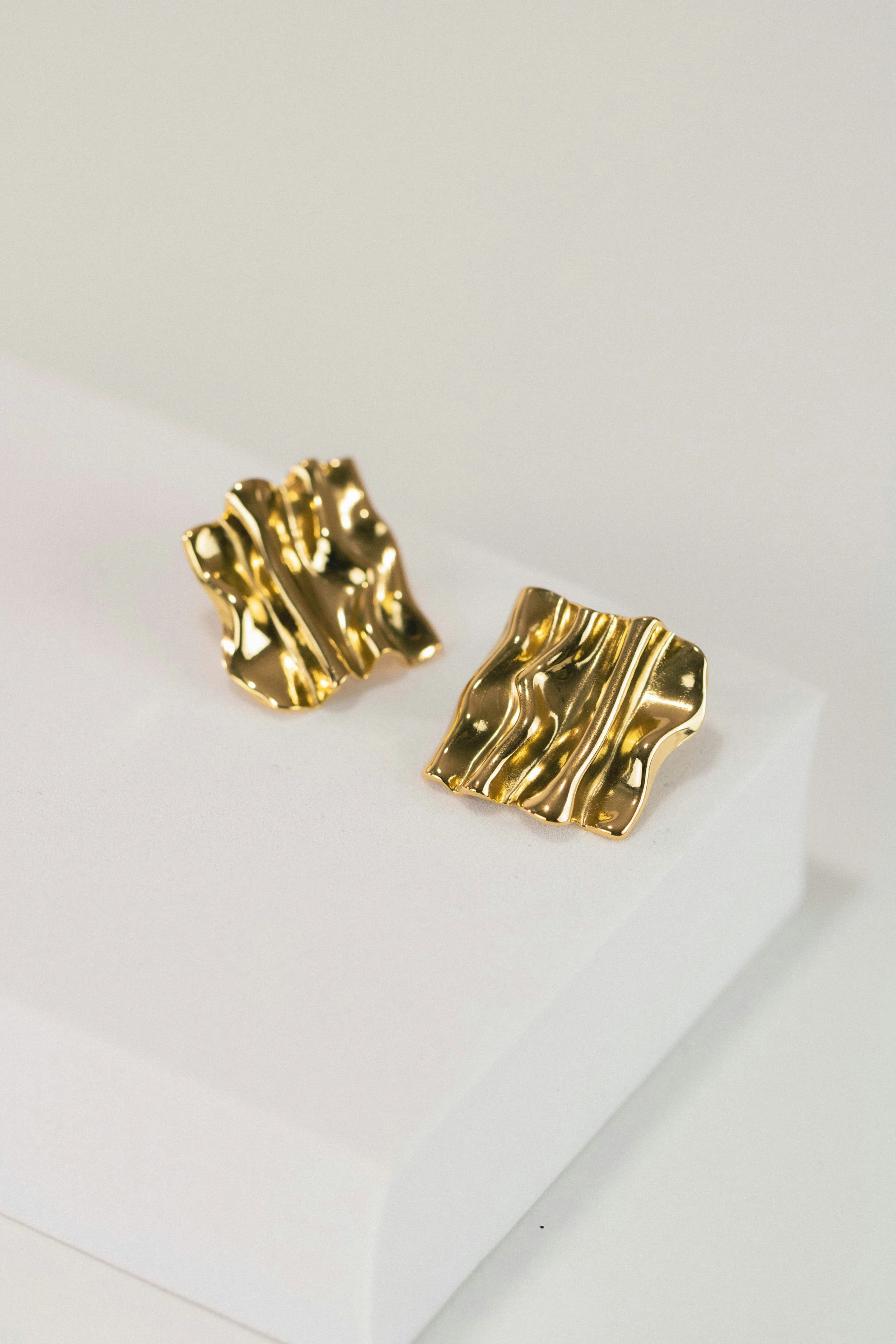 Tidemark — Sheet gold folded over a steel stake until the ripples hold their shape. No two pairs fall the same way.