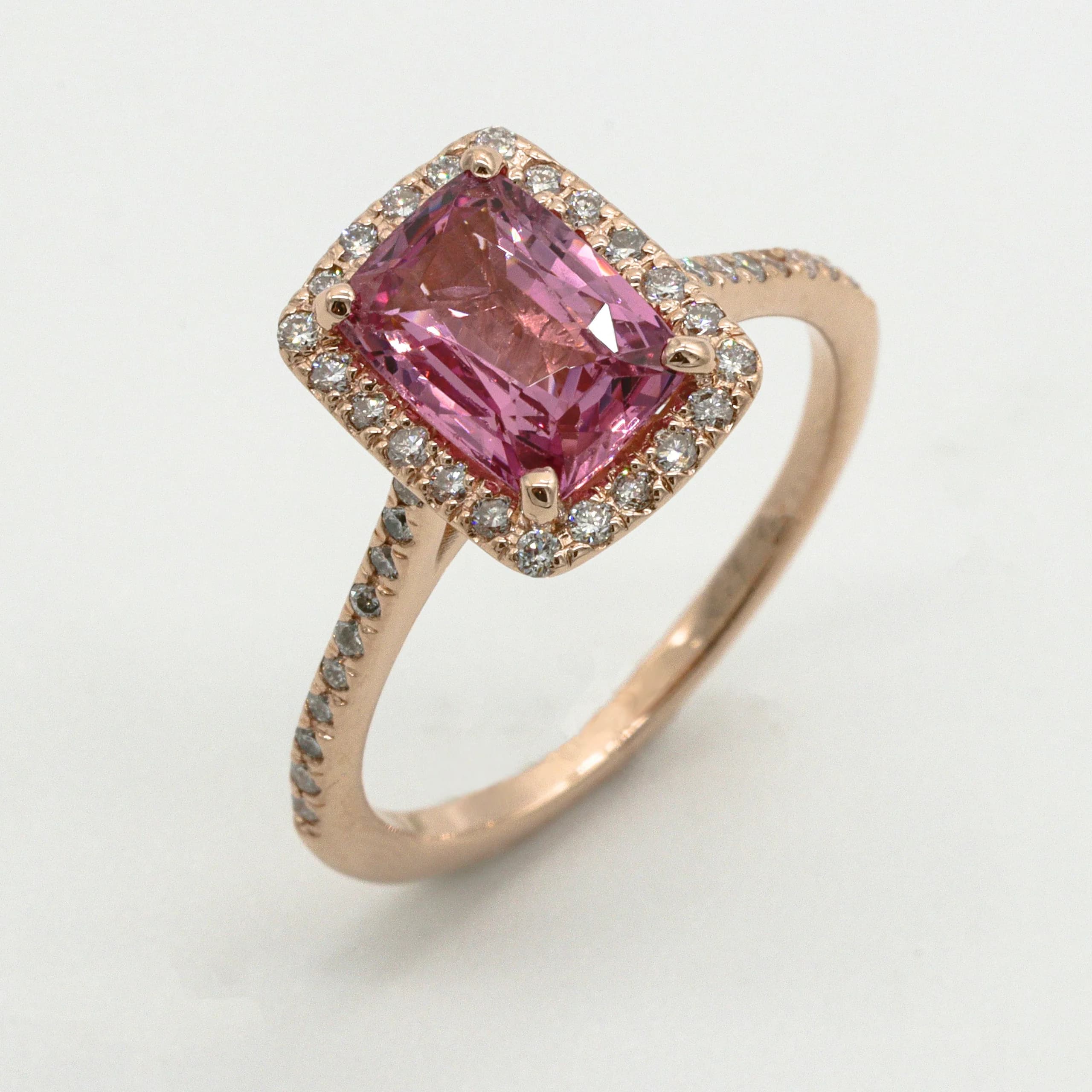 Solstice — A radiant-cut pink sapphire from one Ceylon parcel, haloed in brilliants and cut down into rose gold.