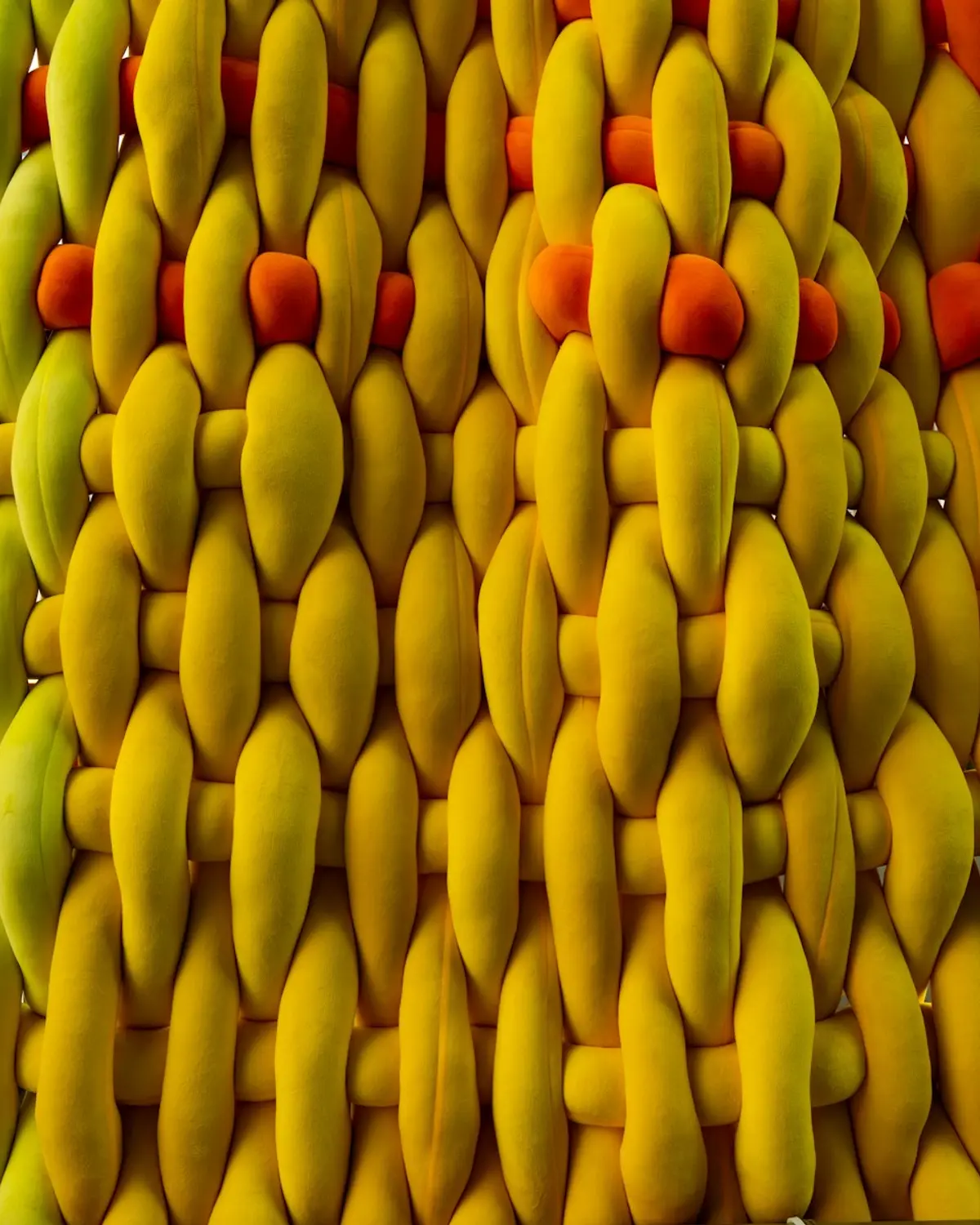 Macro crop of woven cord in lime, volt yellow and orange