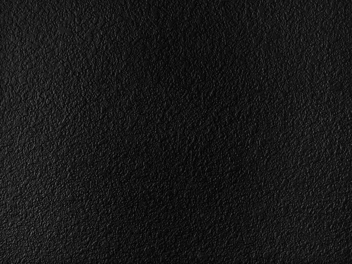 A flat black surface with a fine, even grain and almost no highlight.