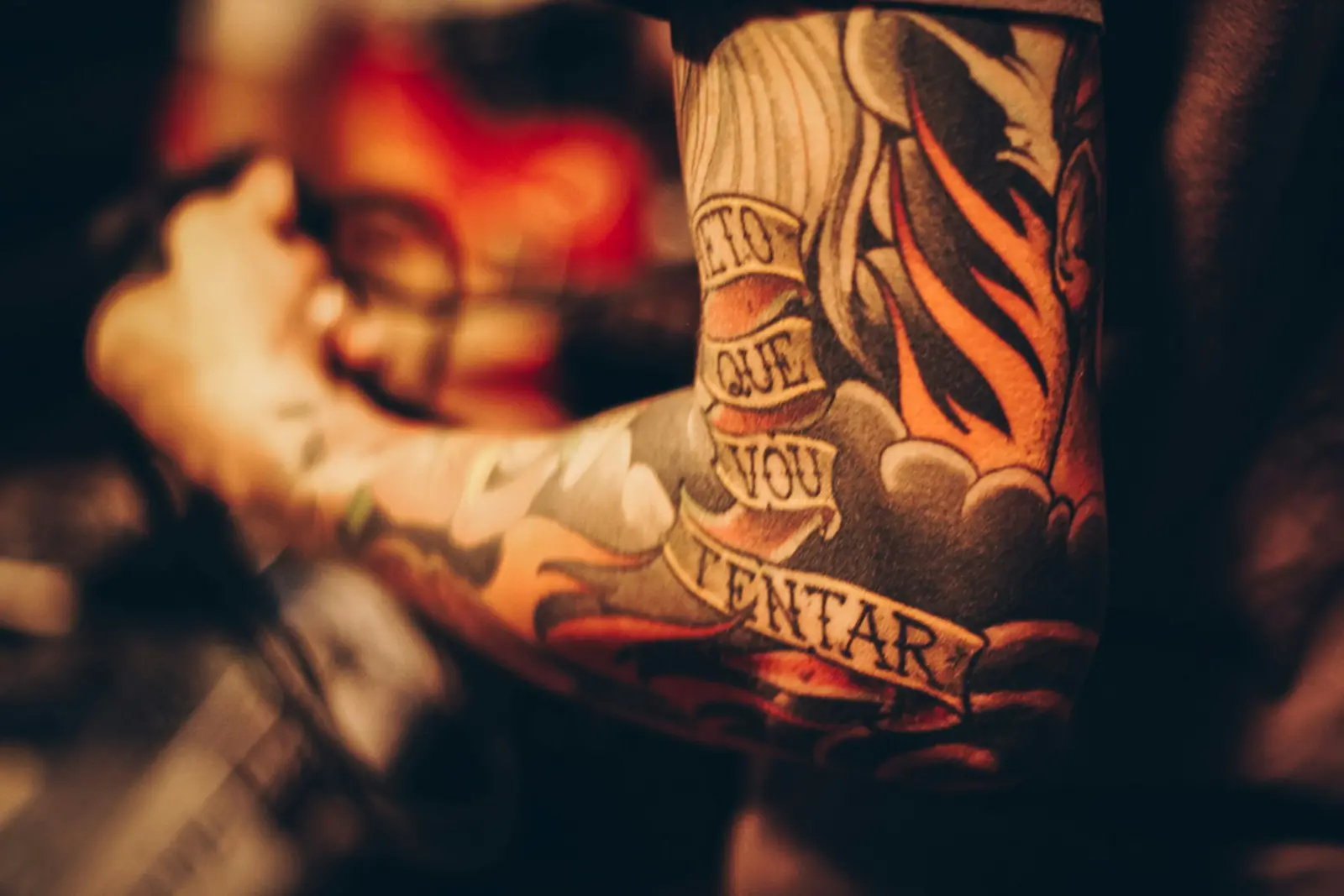 American traditional sleeve with banner lettering in warm tones