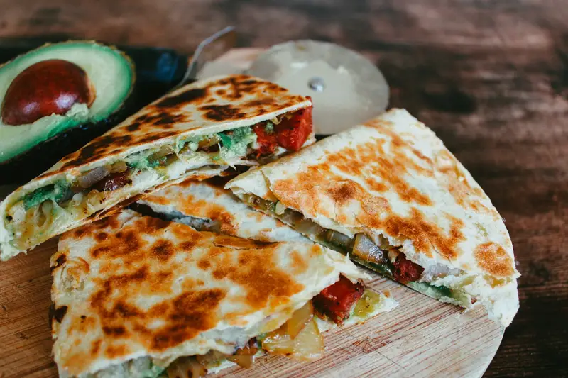Quesadillas hot off the comal with golden griddle marks