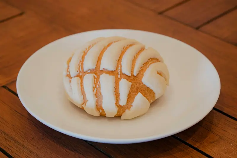 Concha with its crackly shell-pattern sugar top on a plate